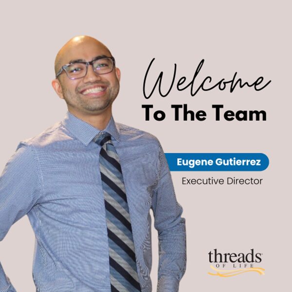 A man stands proudly beside a message that says "Welcome to the team"