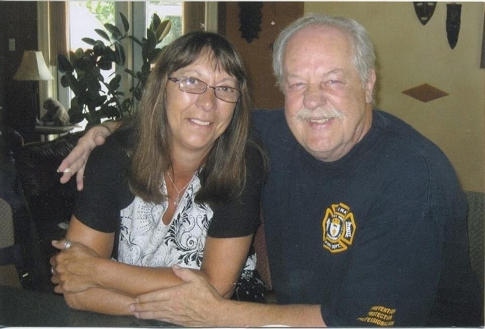 A man and woman smile for the camera.